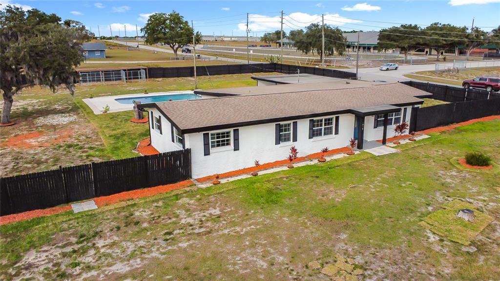 1890 Tyner Road Haines City, FL 33844 - Photo 9 of 48 a aerial view of a house with swimming pool and a yard