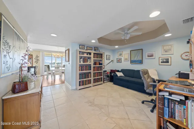 a livingroom with a bookshelf and a workspace