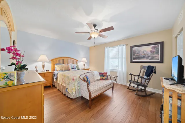 a bedroom with a bed window and a flat screen tv
