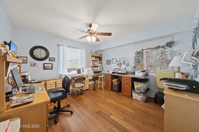 a view of a workspace with furniture and a window