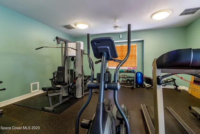 a room with gym equipment and windows