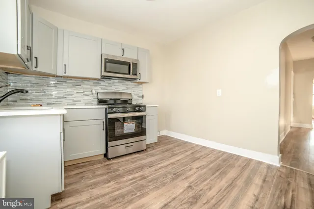 a kitchen with a stove and a microwave