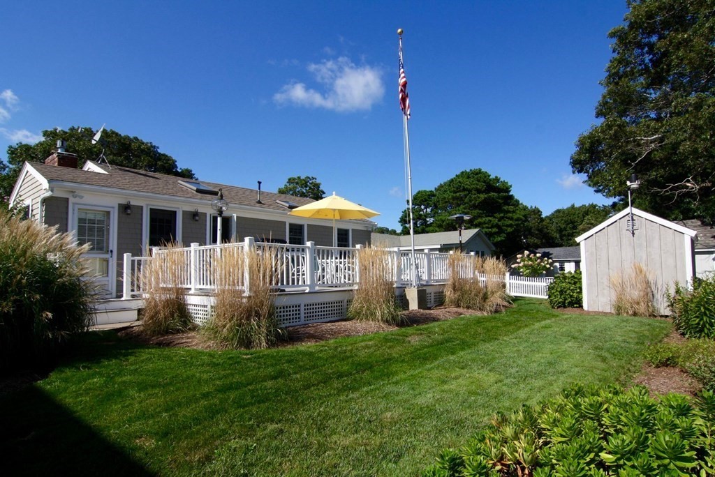 48 Bearse Road Mashpee, MA 02649 - Photo 3 of 42 a front view of a house with a yard table and chairs