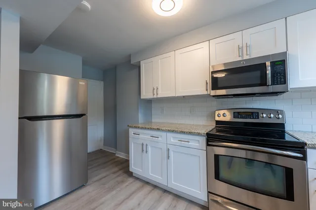 a kitchen with a refrigerator stove and microwave