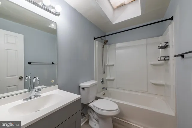 a bathroom with a sink mirror toilet and bathtub