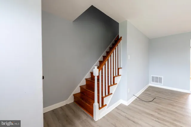 a view of entryway and hall with wooden floor