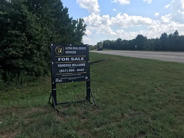 a wooden bench sitting in the middle of a field