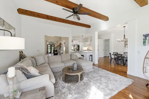 a large kitchen with white cabinets and stainless steel appliances
