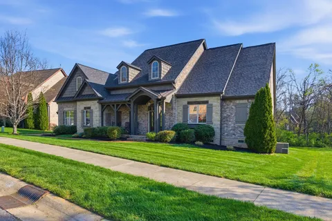 a front view of a house with a yard