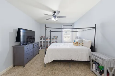 a bedroom with a bed and a chandelier