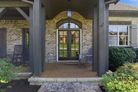 a front view of a house with a garden