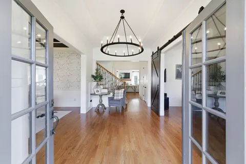 a living room with furniture a fireplace and a floor to ceiling window