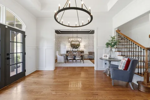 a view of a dining room with furniture and chandelier