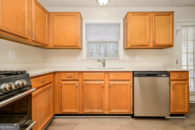 a kitchen with stainless steel appliances granite countertop a refrigerator and a stove
