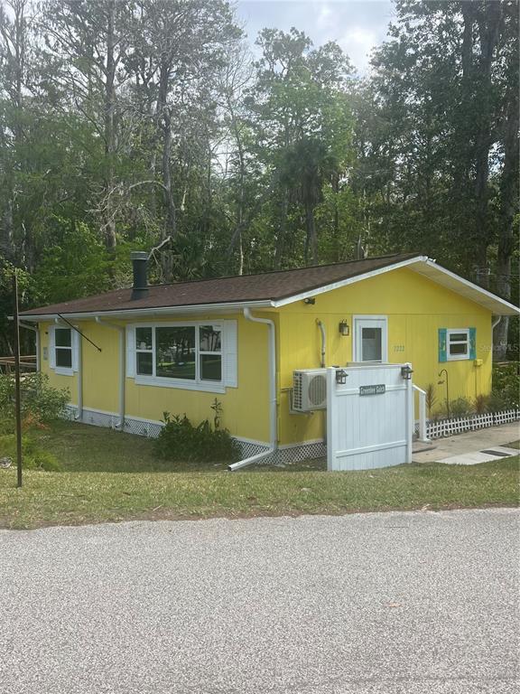 7222 Tropical Drive Weeki Wachee, FL 34607 - Photo 10 of 23 a front view of a house with a yard