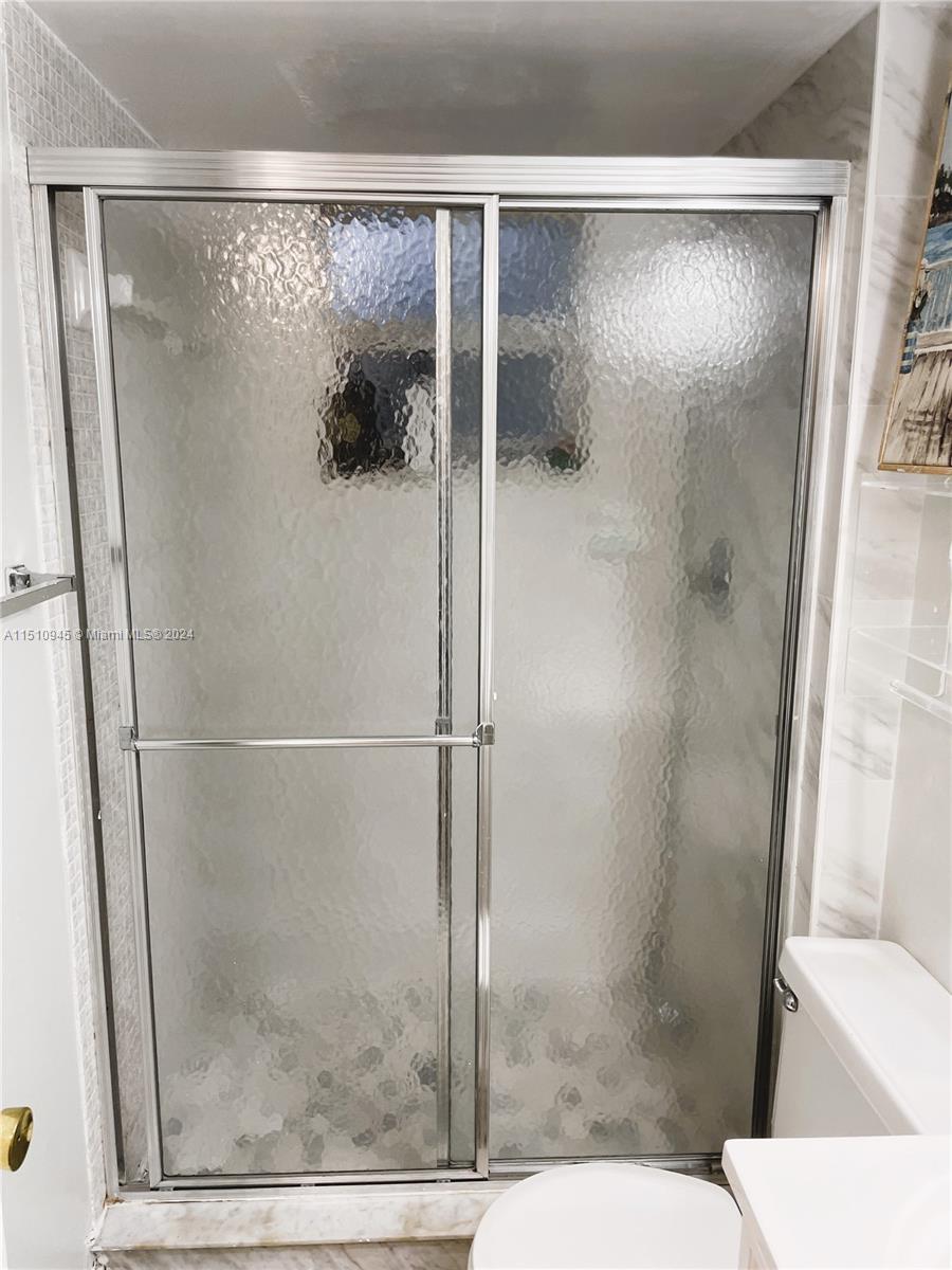 Arrowhead Davie, FL 33324 - Photo 16 of 40 a bathroom with a glass shower door