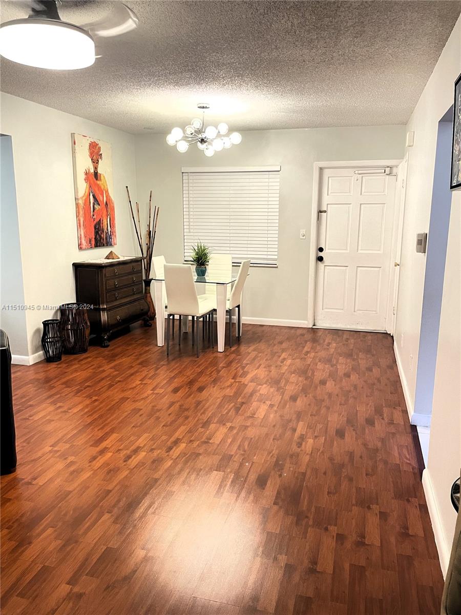 Arrowhead Davie, FL 33324 - Photo 21 of 40 a living room with furniture and a chandelier