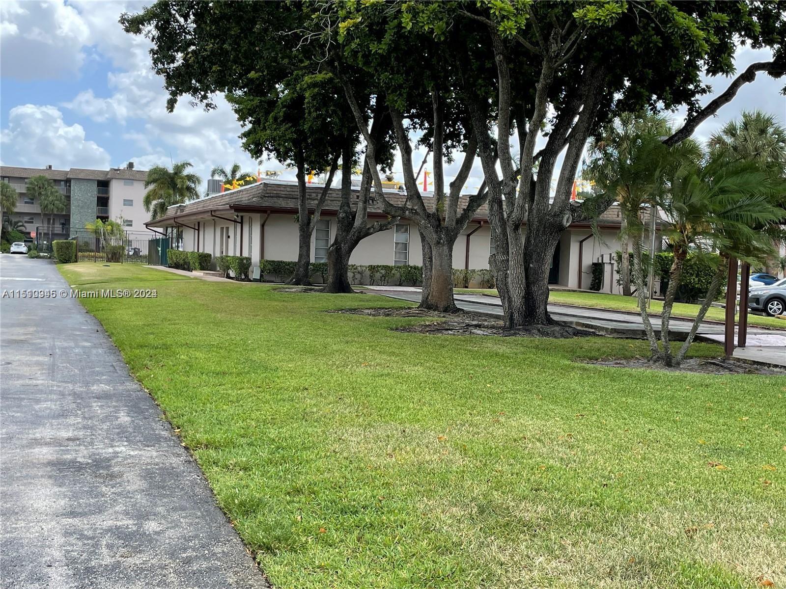 Arrowhead Davie, FL 33324 - Photo 27 of 40 a front view of a house with a garden and trees