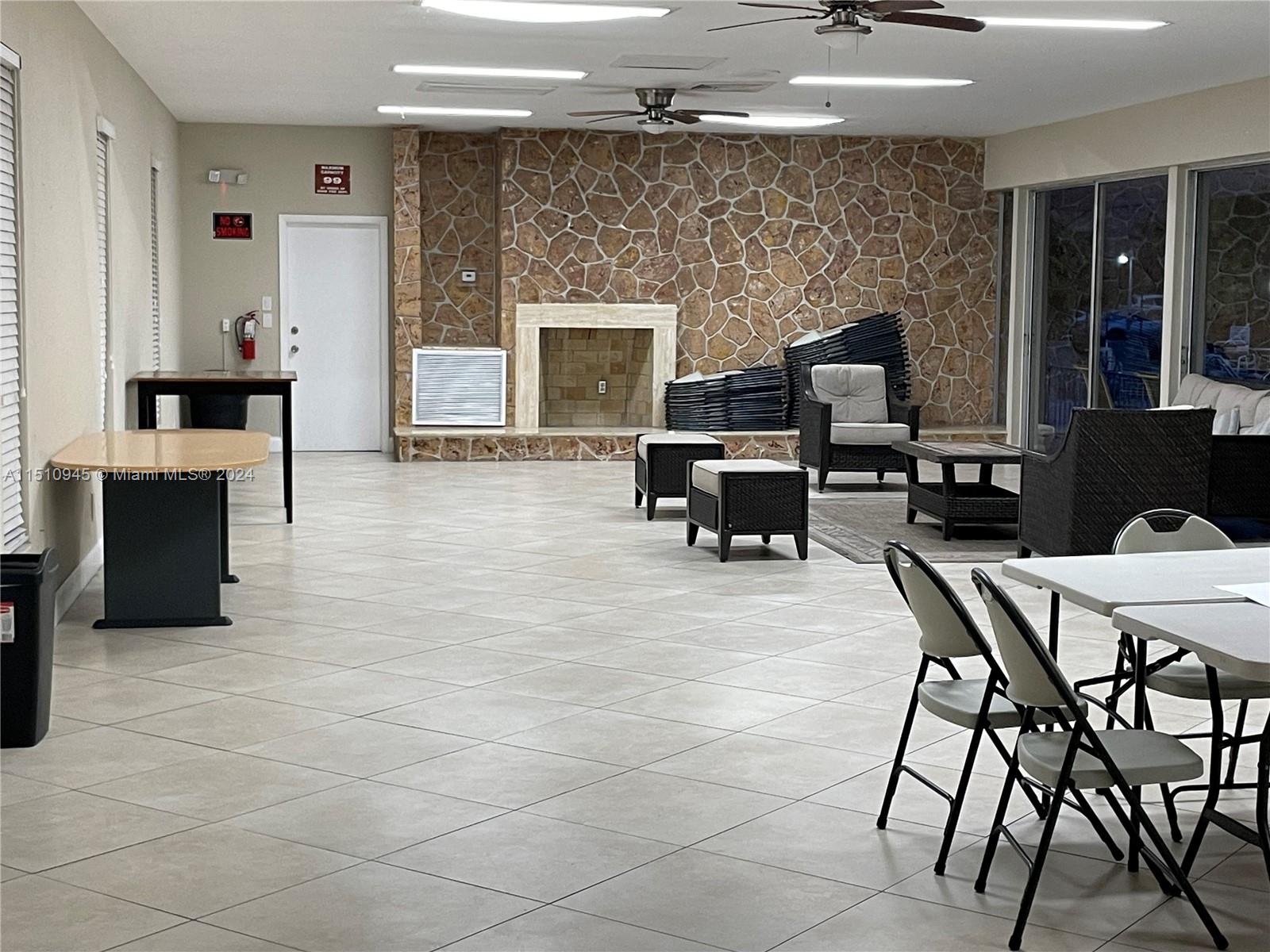 Arrowhead Davie, FL 33324 - Photo 30 of 40 a living room with furniture a fireplace and a flat screen tv