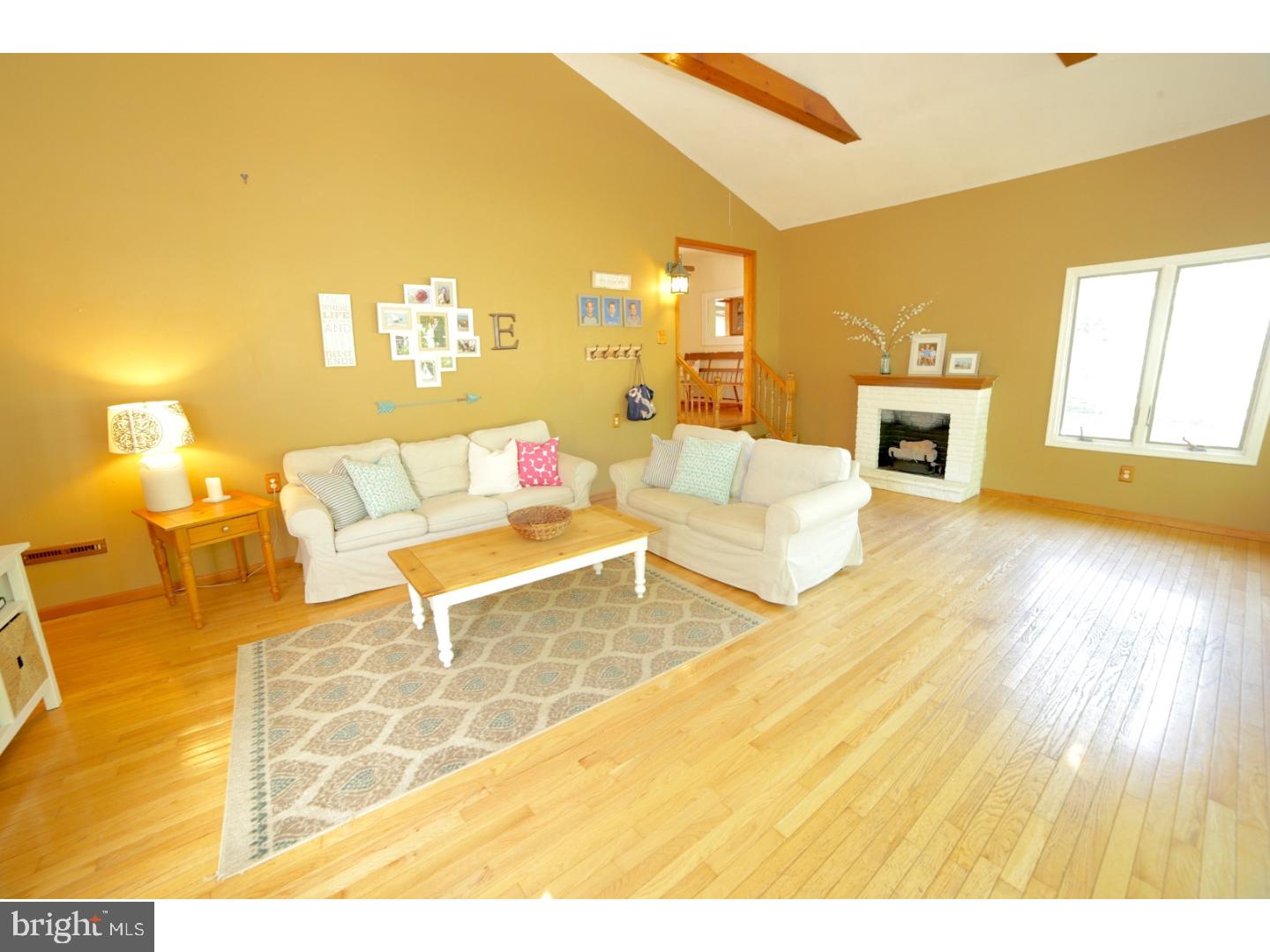 168 Stewart Road Pilesgrove, NJ 08098 - Photo 14 of 17 a living room with couches and kitchen view with wooden floor