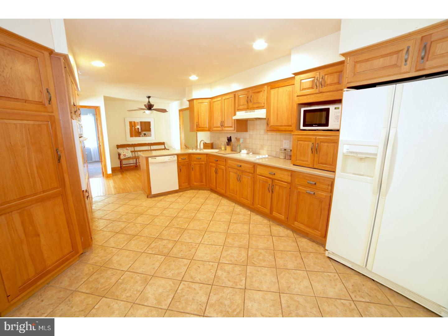 168 Stewart Road Pilesgrove, NJ 08098 - Photo 4 of 17 a large white kitchen with a sink a refrigerator and a stove