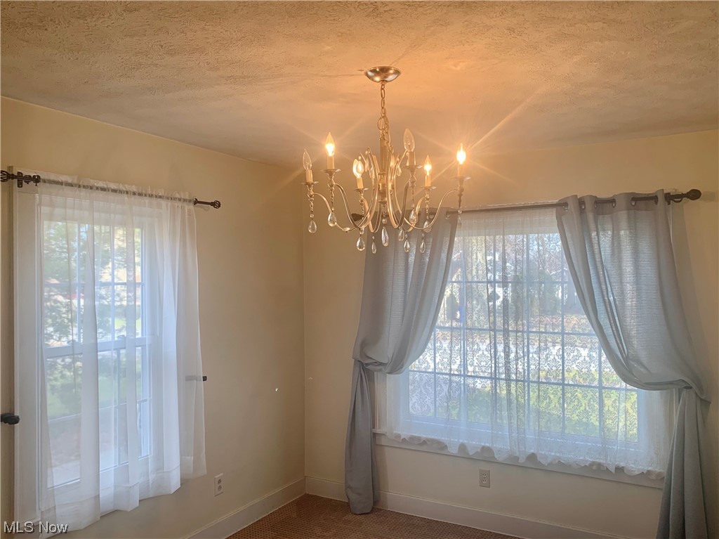 410 Rosedale Street Ravenna, OH 44266 - Photo 11 of 35 Formal dining room with two windows & chandelier