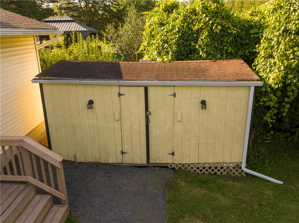 1644 9th Street Bethlehem, PA 18020 - Photo 25 of 27 A quaint yellow storage shed with double doors offers practical outdoor organization.
