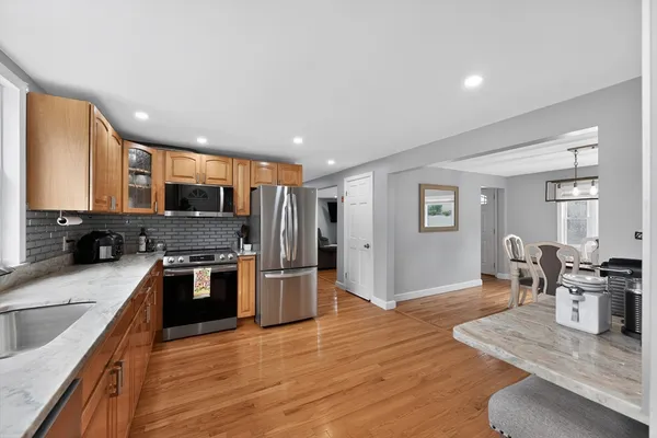 a kitchen with stainless steel appliances granite countertop a refrigerator stove microwave and sink