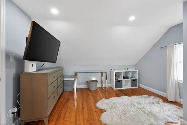 a bedroom with furniture and flat screen tv