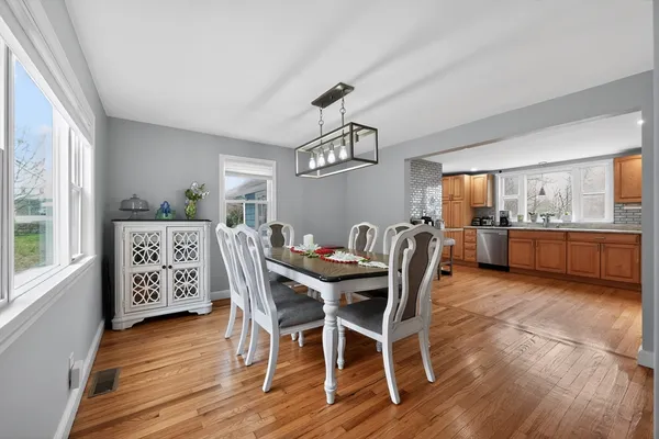 a view of a dining room with furniture window and wooden floor