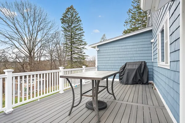 a view of balcony with wooden floor and outdoor seating