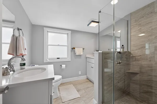 a bathroom with a sink toilet and shower