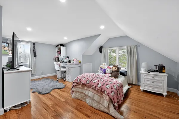 a bedroom with a bed and a large window