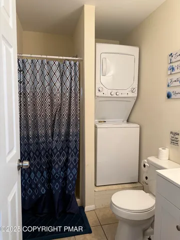 a white toilet sitting next to a shower curtain