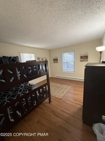 a bedroom with a bed window and a dresser