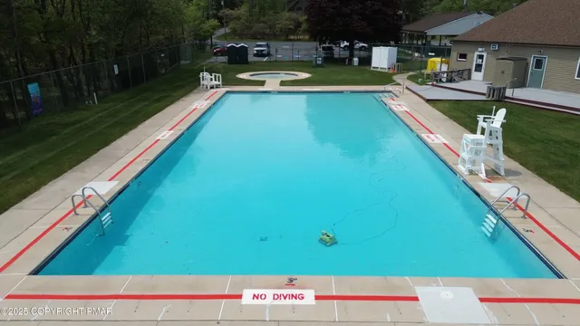 a view of swimming pool with lounge chair and dinning table