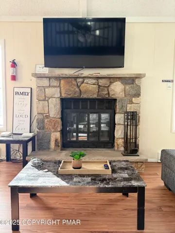 a view of living room with furniture and wooden floor
