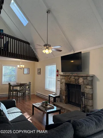 a living room with furniture a flat screen tv and a fireplace