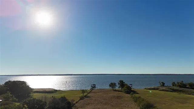 a view of a yard with wooden fence