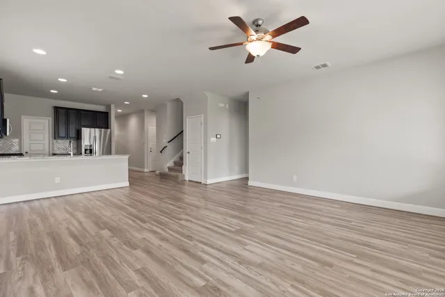 a view of a kitchen with a dishwasher and wooden floor