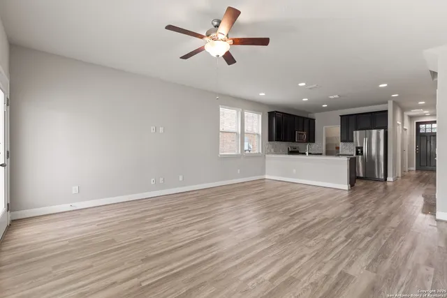 a view of a kitchen with a stove cabinets and wooden floor