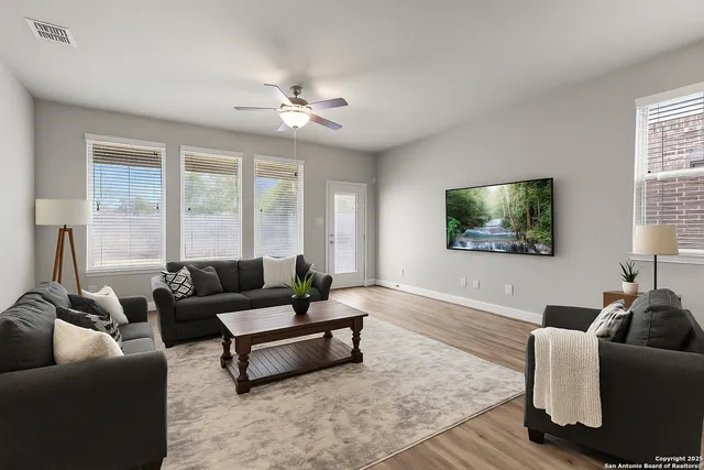 a living room with furniture and a flat screen tv