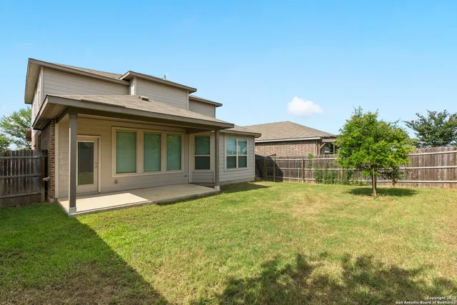 a view of a house with a yard and plants
