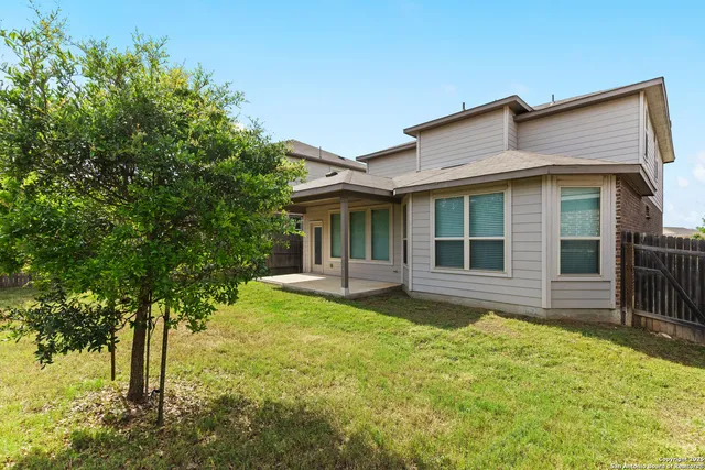 a view of a house with a yard and sitting area