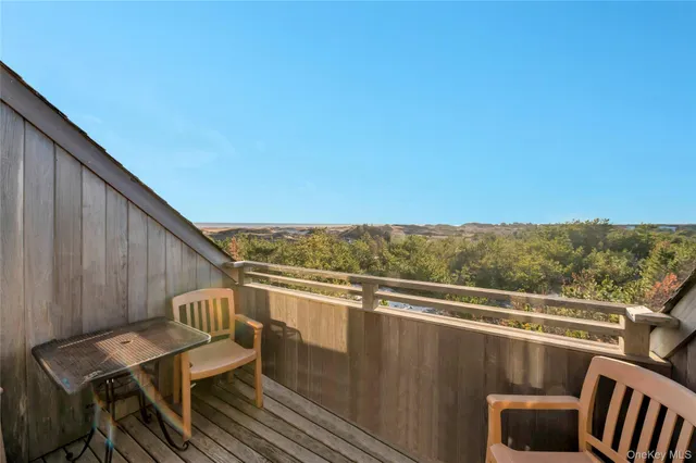a view of a chair and table on the balcony