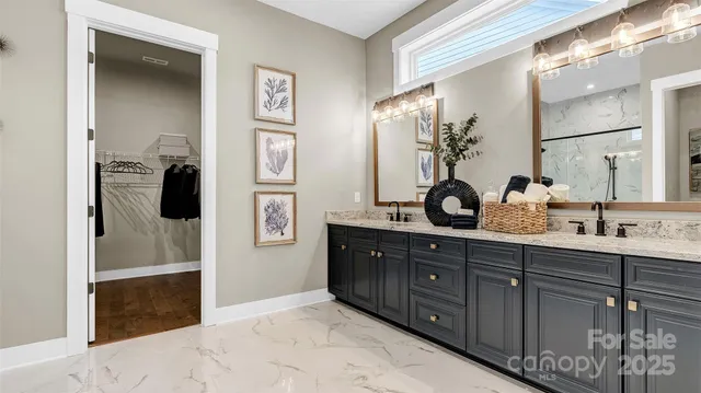 a spacious bathroom with double vanity and a mirror