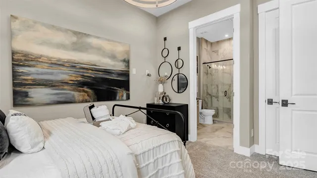 a bedroom with a bed a mirror and a shower