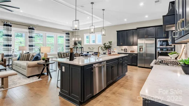 a large kitchen with stainless steel appliances kitchen island granite countertop a large counter top stainless steel appliances and cabinets
