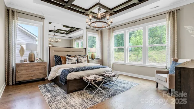 a bedroom with a bed mirror and window