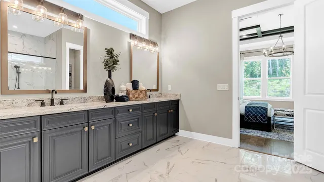 a spacious bathroom with a granite countertop sink and a mirror